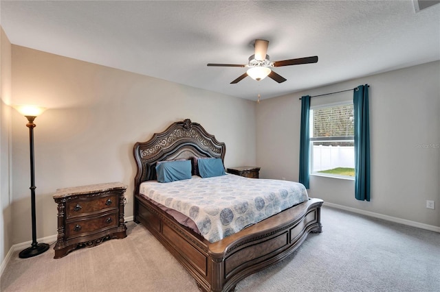 bedroom with light carpet, a textured ceiling, and ceiling fan