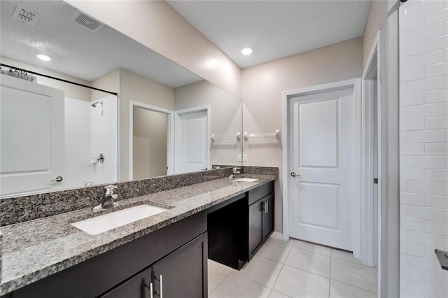 bathroom featuring a shower, vanity, and tile patterned floors