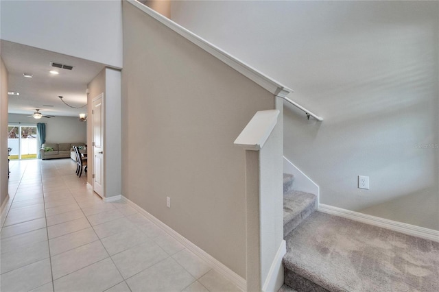 stairs with tile patterned floors and ceiling fan