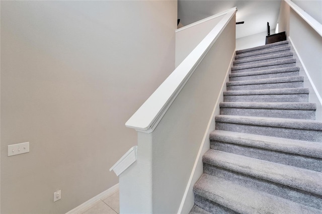 stairs featuring tile patterned floors