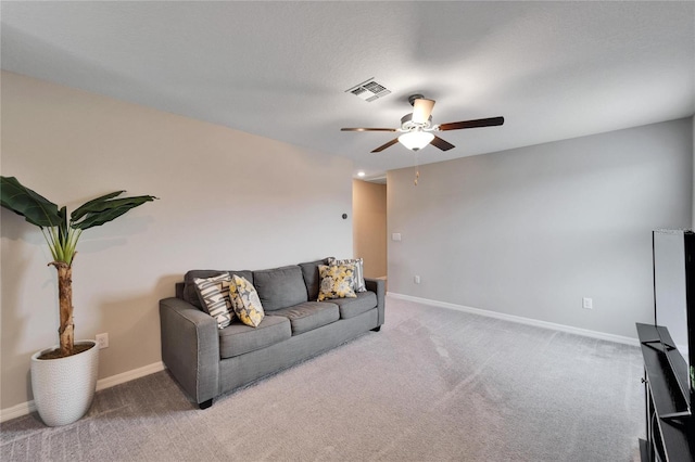 living room with ceiling fan and carpet floors