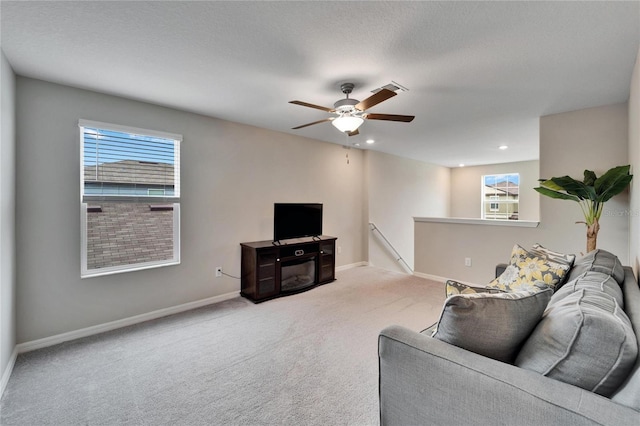 living room featuring light carpet and ceiling fan