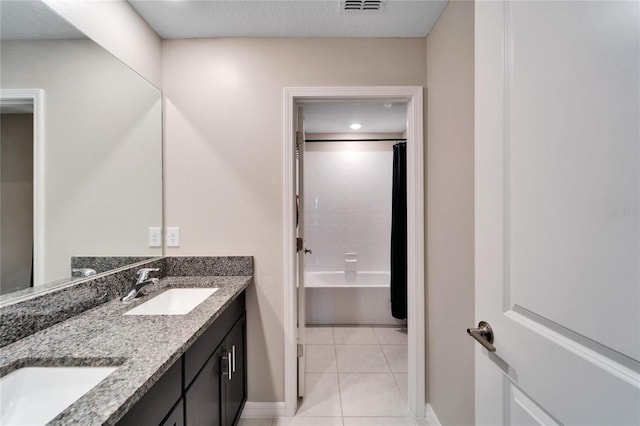 bathroom with bathing tub / shower combination, tile patterned flooring, and vanity