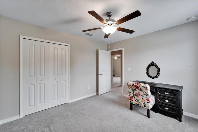 interior space featuring ceiling fan and a closet