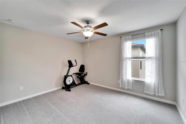 workout room with carpet flooring, a textured ceiling, and ceiling fan