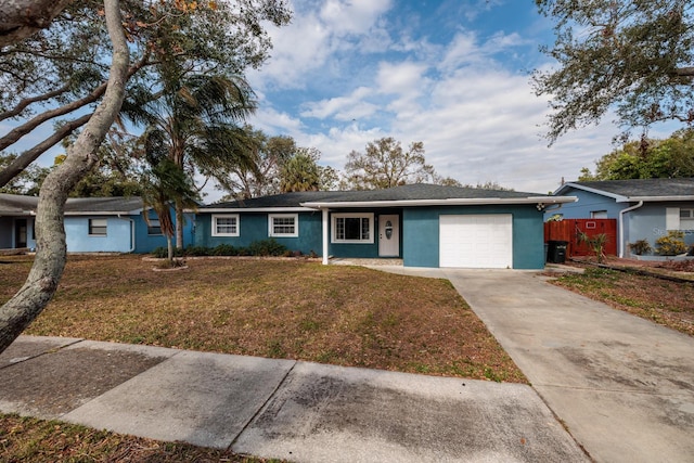 single story home with a garage and a front lawn