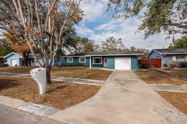 ranch-style home featuring a front yard and a garage