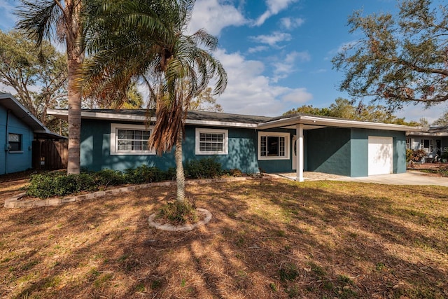 single story home with a front lawn and a garage