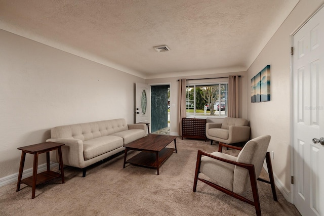 living room with light carpet and a textured ceiling