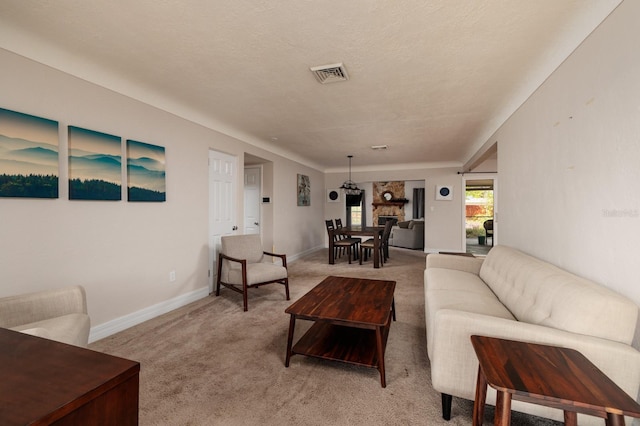 carpeted living room featuring a textured ceiling