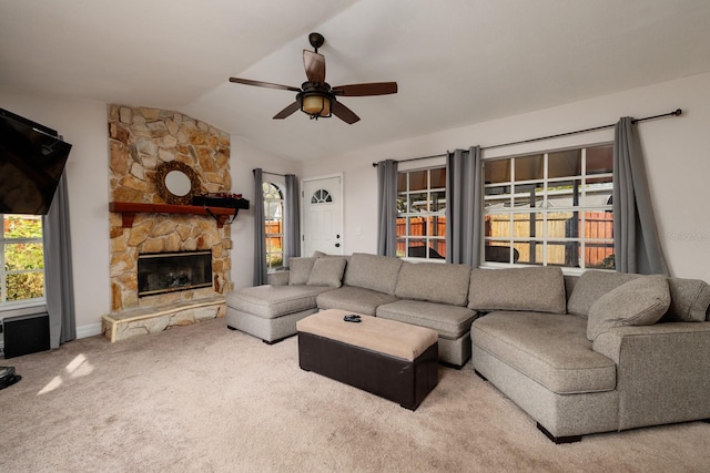 carpeted living room featuring ceiling fan, a fireplace, and vaulted ceiling