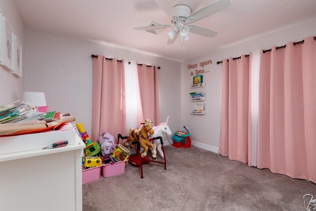 rec room with ceiling fan and light colored carpet