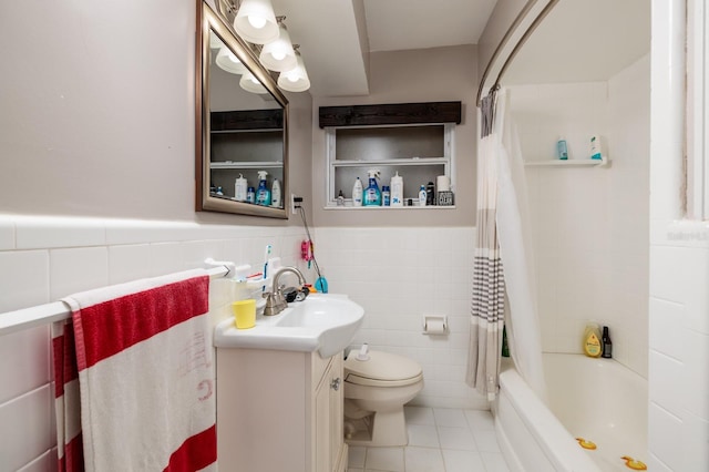 full bathroom with shower / tub combo, vanity, toilet, and tile walls