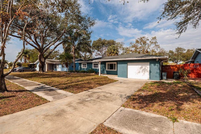 single story home featuring a front lawn and a garage