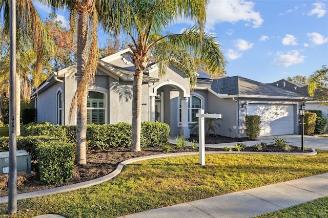 view of front of home featuring a garage and a front lawn