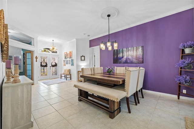 tiled dining room with french doors, ornamental molding, and a notable chandelier