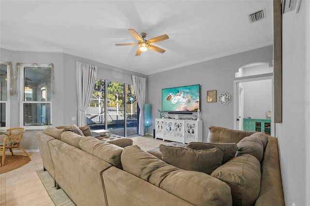 living room featuring ceiling fan, light tile patterned floors, and crown molding