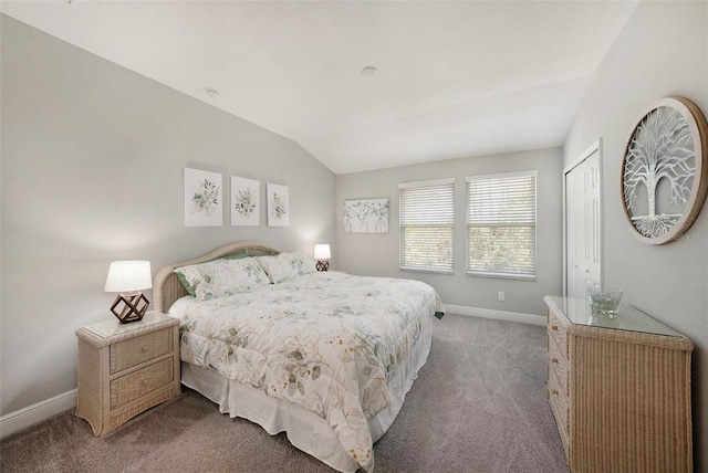 bedroom with light carpet, vaulted ceiling, and a closet