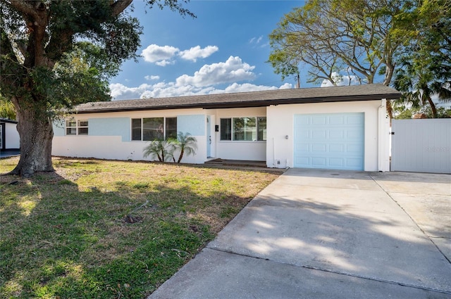 single story home featuring a garage and a front lawn