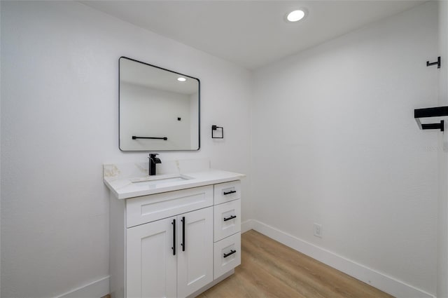 bathroom with vanity and wood-type flooring