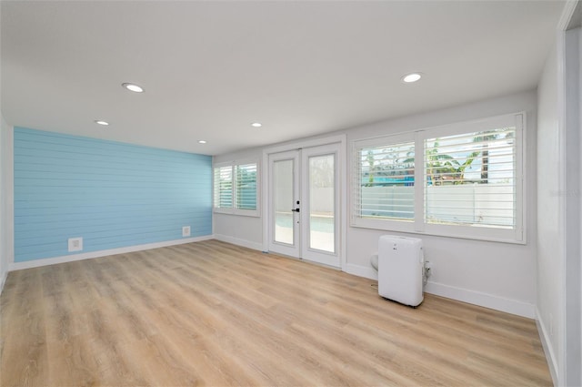 interior space with light hardwood / wood-style floors and a wealth of natural light