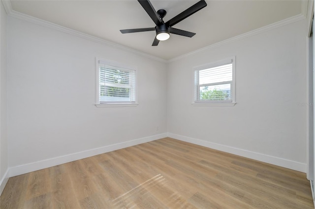 spare room with a wealth of natural light, light wood-type flooring, and ornamental molding