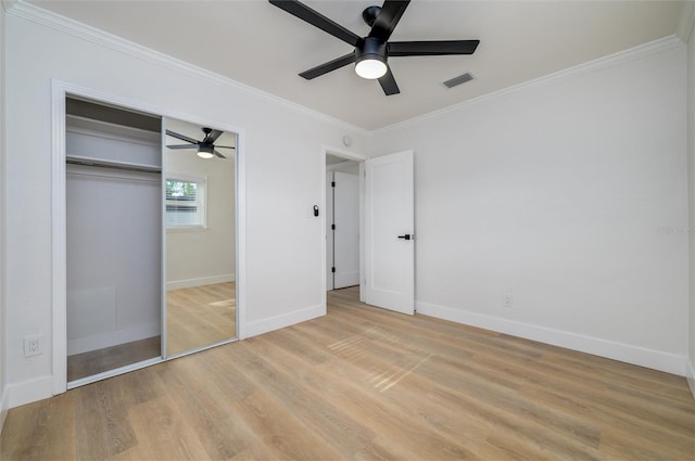 unfurnished bedroom featuring a closet, ceiling fan, crown molding, and light hardwood / wood-style floors