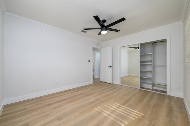 unfurnished bedroom featuring crown molding, ceiling fan, a closet, and light hardwood / wood-style floors