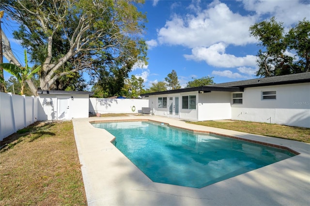 view of swimming pool with central air condition unit, a shed, and a lawn