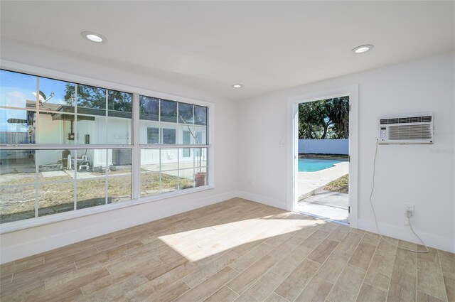 unfurnished room with a wall mounted air conditioner