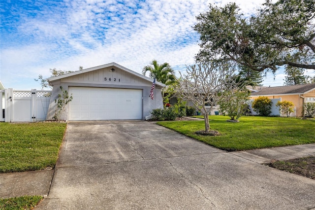 ranch-style house featuring a garage and a front lawn