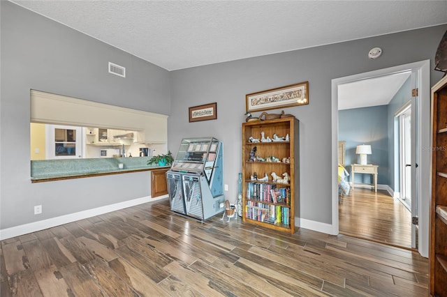 misc room featuring hardwood / wood-style flooring and a textured ceiling