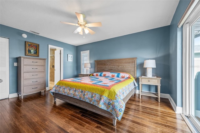 bedroom with dark hardwood / wood-style floors, ensuite bath, and ceiling fan