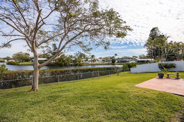 view of yard featuring a patio area and a water view