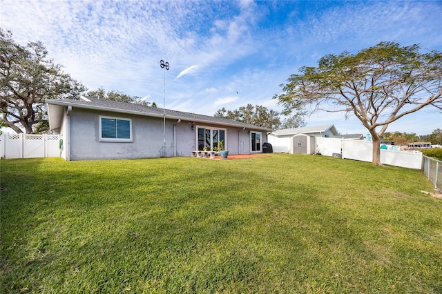 back of property featuring a lawn and a storage unit