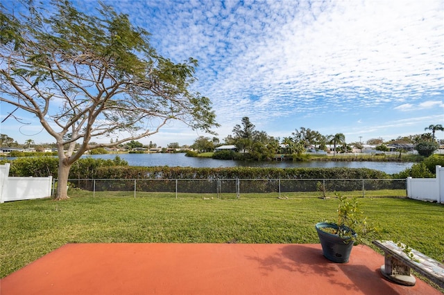 view of yard with a water view and a patio