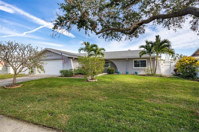 single story home with a front yard and a garage