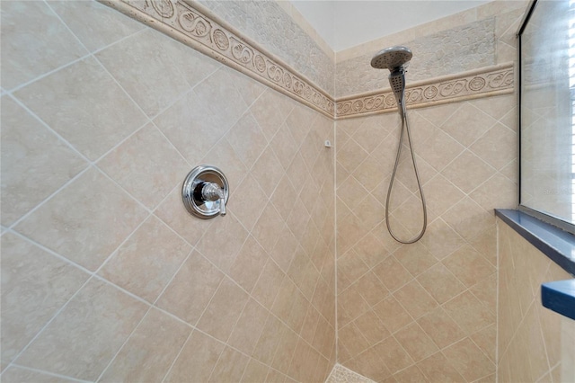 bathroom with tiled shower