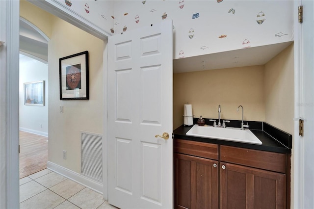 bathroom featuring tile patterned flooring and vanity