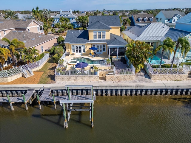 back of house with french doors and a water view