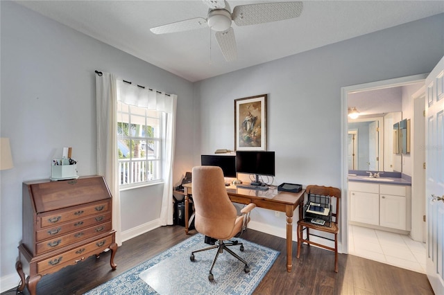 home office featuring ceiling fan, dark hardwood / wood-style flooring, and sink