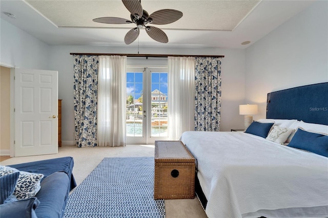 carpeted bedroom with french doors and ceiling fan