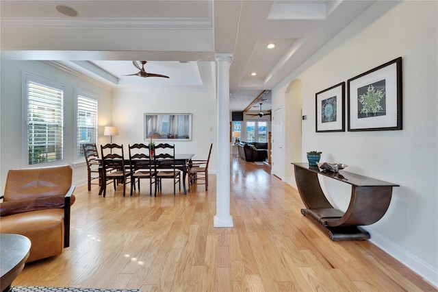 dining area featuring ornamental molding, ceiling fan, light hardwood / wood-style flooring, and ornate columns