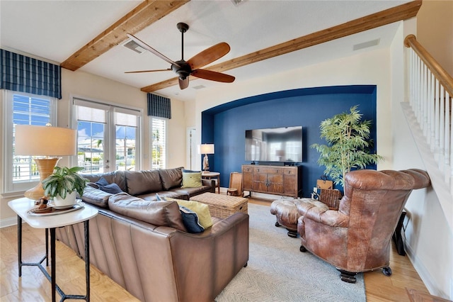 living room with french doors, ceiling fan, beamed ceiling, and light hardwood / wood-style flooring