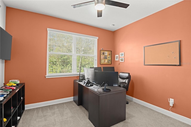 carpeted office featuring ceiling fan