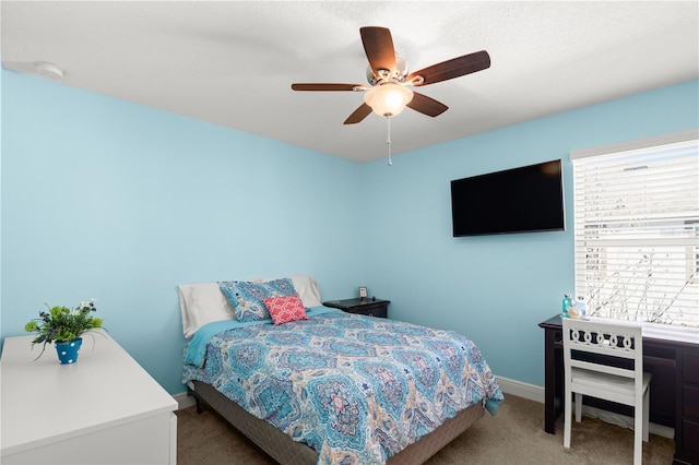 bedroom featuring multiple windows, carpet, and ceiling fan