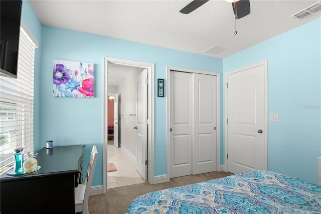 carpeted bedroom with ceiling fan and a closet