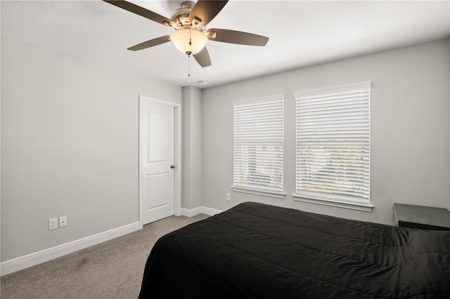 bedroom featuring light carpet and ceiling fan