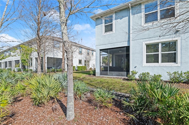 rear view of property featuring a sunroom