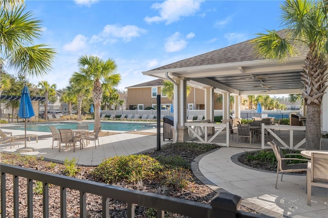 view of swimming pool featuring a patio area and ceiling fan